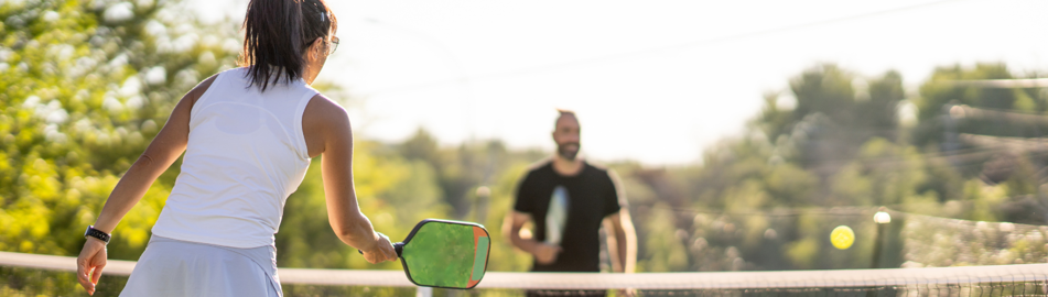 image of couple playing pickleball